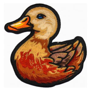 May include: Embroidered duck patch with a black border. The duck features shades of orange, brown, and tan, with a bright orange beak and a blue eye. This patch is suitable for jackets, bags, or other fabric items.