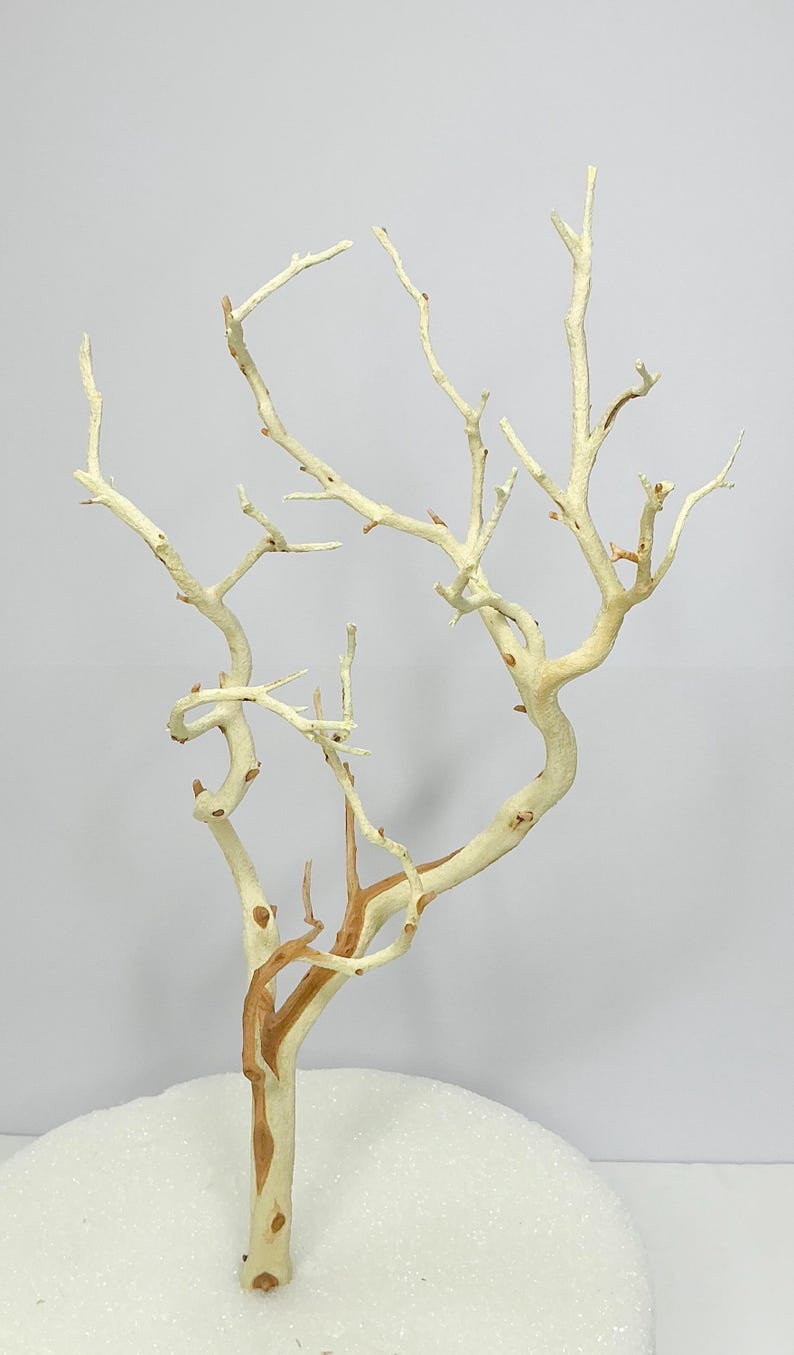 May include: A white and brown driftwood branch tree with a white base. The tree is a decorative piece for a home or office.