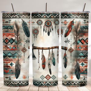 May include: Three stainless steel insulated tumblers with a Native American-inspired design. The design features feathers, dream catchers, and an axe, with a color palette of red, turquoise, and cream. Each tumbler has a silver straw.