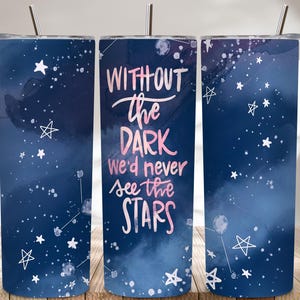 May include: A set of three stainless steel tumblers with lids and straws. The tumblers feature a dark blue watercolor design with white stars and the text "WITHOUT the DARK we'd never see the STARS" in pink and white.