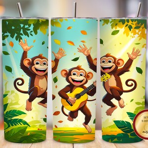 May include: A cylindrical tumbler with a metal straw featuring a cartoon monkey illustration. The design shows monkeys jumping and playing a yellow guitar amidst green foliage and falling leaves. A circular badge reads Set of 5 Designs.