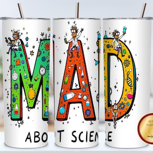Könnte beinhalten: Weißer Becher mit dem Schriftzug "MAD ABOUT SCIENCE" in bunten Buchstaben. Die Buchstaben sind mit Illustrationen zum Thema Wissenschaft und Cartoon-Wissenschaftlern verziert. Ein Set mit 5 Designs ist ebenfalls abgebildet.