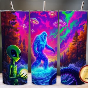 May include: Set of 5 stainless steel tumblers with vibrant, surreal illustrations. Designs include a green alien holding a glowing orb, a blue Bigfoot, and a purple tentacled creature, all set against a colorful, otherworldly landscape with UFOs.