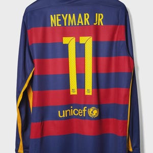 May include: A long-sleeved soccer jersey with horizontal red and blue stripes. The jersey features the name "NEYMAR JR" and the number "11" in yellow. The UNICEF logo is also visible.