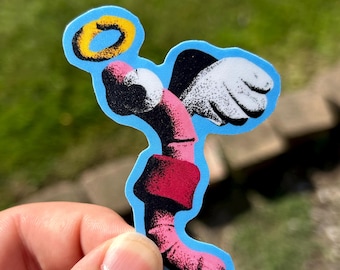 May include: A die-cut sticker featuring a stylized pink and black worm character with white wings and a yellow halo above its head. The design uses a stippled texture effect with a bright blue outline, depicting the worm in a curved pose.