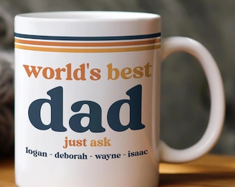 May include: White ceramic mug with the words "world's best dad" in orange and navy blue. The mug has a handle and is decorated with orange and blue stripes. The names "logan - deborah - wayne - isaac" are printed below the main text.