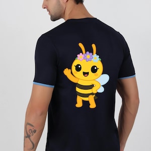 May include: Navy blue t-shirt featuring a cartoon bee with a flower crown and waving. The bee is yellow with black stripes and blue wings. The shirt has a blue trim on the sleeves.