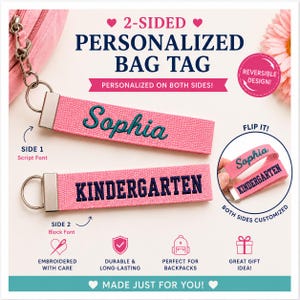 May include: A two-sided personalized pink fabric bag tag with a silver metal keyring. One side features the name Sophia embroidered in a teal script font, while the other side displays the word KINDERGARTEN in a dark blue block font.