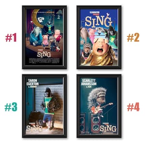 May include: Four framed movie posters for the animated film "Sing." The posters showcase characters and scenes from the movie, with bright colours and the film's title clearly visible. Each poster is in a black frame.