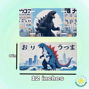May include: Two license plates featuring Godzilla illustrations. The top plate shows a black Godzilla against a cityscape and a blue sky. The bottom plate displays a blue Godzilla with red spines, also against a cityscape. Each plate is 12 inches wide and 6 inches tall.