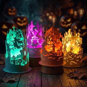 May include: Four cylindrical paper lanterns featuring intricate Halloween-themed cutouts of witches, haunted houses, pumpkins, and trees. Each lantern is illuminated from within, casting vibrant green, purple, orange, and yellow light.