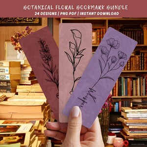 May include: Three botanical floral bookmarks in shades of mauve, pink, and purple are held in a hand. Each bookmark features a different floral design in black line art. The top of the image reads "BOTANICAL FLORAL BOOKMARK BUNDLE". The word "Whisper" is written on one bookmark.