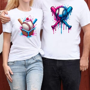 May include: Two white t-shirts with a baseball theme. One shirt features a baseball in a waffle cone with a cherry on top and dripping blue and pink paint. The other shirt features two crossed baseball bats with a baseball in the middle and dripping blue and pink paint.