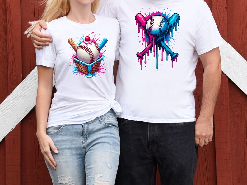 May include: Two white t-shirts with a baseball theme. One shirt features a baseball in a waffle cone with a cherry on top and dripping blue and pink paint. The other shirt features two crossed baseball bats with a baseball in the middle and dripping blue and pink paint.