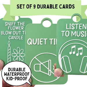 May include: A set of nine green rectangular communication cards with rounded corners and a hole at the top. The cards feature white embossed text and icons including Sniff the Flower, Blow Out the Candle, Quiet Time, and Listen to Music. The text reads Set of 9 Durable Cards, Durable Waterproof Kid-Proof, and Talkies Communication Cards.