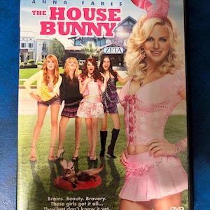 May include: DVD cover for the movie "The House Bunny" starring Anna Faris. The cover features a pink bunny ear headband, a pink skirt, and a pink top. The text "The House Bunny" is in large, white letters.