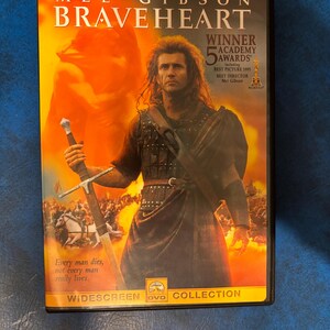 May include: DVD cover for the movie Braveheart starring Mel Gibson. The cover features a close-up of Mel Gibson as William Wallace, holding a sword, with a battle scene in the background. The text on the cover reads "Mel Gibson Braveheart" and "Winner 5 Academy Awards Including Best Picture 1995 Best Director Mel Gibson".