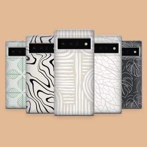 May include: Five mobile phone cases with diverse patterns, including leaf, wave, and geometric designs. The cases feature a neutral colour palette of white, black, and beige. The cases are arranged in a row, showcasing their unique designs.