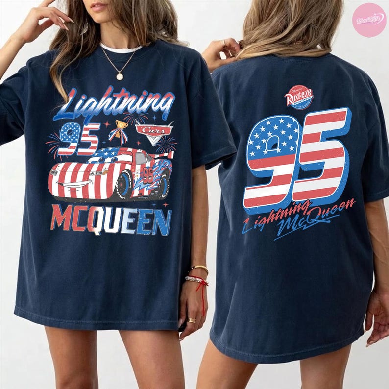 May include: Navy blue t-shirt featuring a graphic of Lightning McQueen from the Cars movie. The front design includes the text "Lightning 95 McQueen" with a patriotic color scheme. The back of the shirt displays a large "95" with the text "Lightning McQueen".