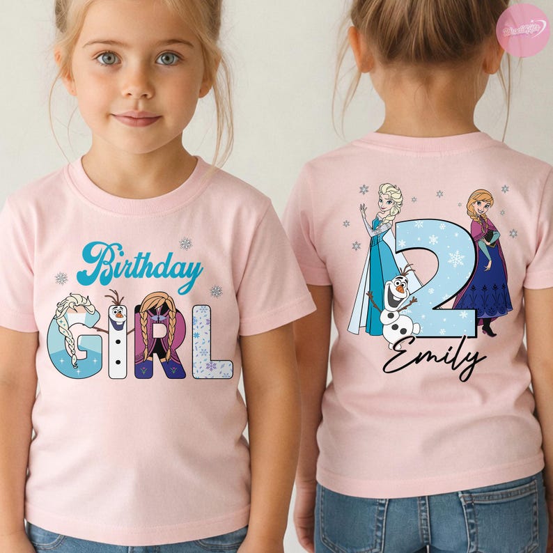 May include: Pink short-sleeved t-shirt with a graphic design featuring the text "Birthday Girl" and characters from a popular animated movie. The back of the shirt displays the number "2" with the name "Emily".