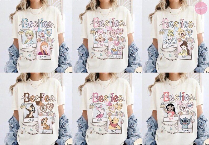 Puede incluir: Camisetas color crema con la palabra "Besties" en fuente cursiva. Cada camiseta presenta un par diferente de personajes de dibujos animados en marcos estilo polaroid, con corazones y estrellas decorativas. Las camisetas son parte de una colecci&oacute;n tem&aacute;tica de Disney.