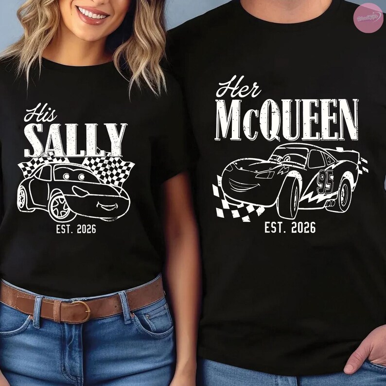 May include: Black t-shirts with white graphics. One shirt says "His Sally" with a car illustration and "EST. 2026". The other says "Her McQueen" with a car illustration and "EST. 2026".