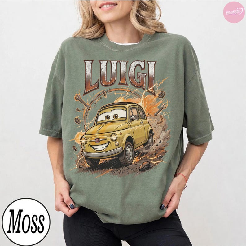 May include: Olive green t-shirt featuring a cartoon image of Luigi, a yellow car from the movie Cars. The word "Luigi" is printed above the car in a brown and orange font. The shirt has a crew neck and short sleeves.
