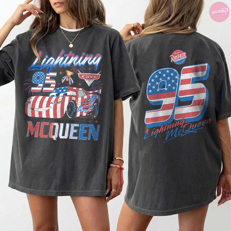 May include: Dark gray Lightning McQueen t-shirt featuring a graphic of the character and the number 95 in red, white, and blue. The front of the shirt has the text "Lightning McQueen" and "Cars". The back of the shirt has the number 95 and "Lightning McQueen".