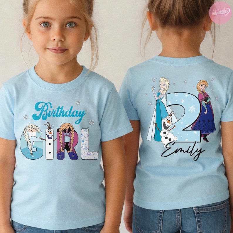 May include: Light blue t-shirts with a birthday theme. The front of the shirt says "Birthday Girl" with images of Elsa, Olaf, and Anna. The back of the shirt has the number "2", the name "Emily", and images of Elsa and Anna.