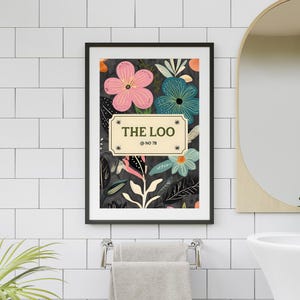 May include: A framed floral print with a black border, featuring pink, teal, and blue flowers against a dark background. The print includes the text "THE LOO" and "@ NO 78" in a cream-coloured plaque.
