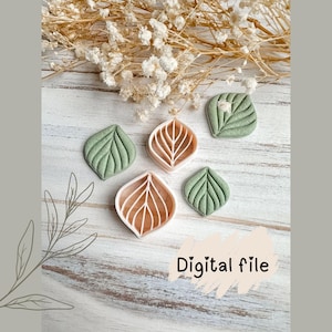 Peut inclure: Cinq objets en forme de feuilles, dans des tons de vert et de marron, sont disposés sur une surface en bois blanc. Les feuilles présentent des motifs de veines détaillés. Le texte "Digital file" est visible.