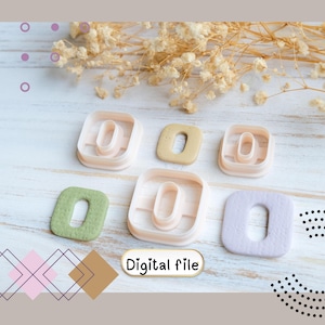 May include: An assortment of letter "O" shaped cookie cutters in various colors, including green, beige, and lavender. The cutters are arranged on a light wooden surface with dried flowers. The text "Digital file" is visible.