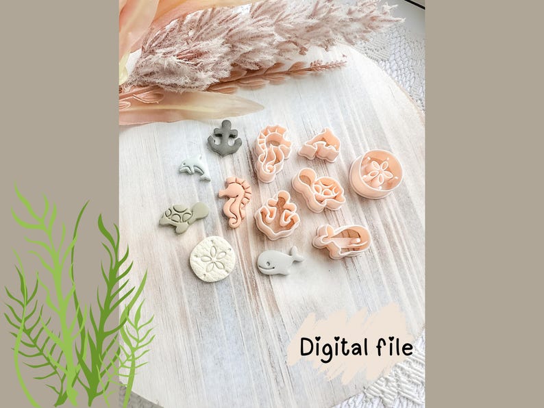 May include: A selection of sea-themed cookie cutters, featuring a seahorse, turtle, and anchor, in shades of pink, grey, and white. They are arranged on a light wood surface. The words "Digital file" are also visible.