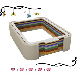 Puede incluir: Un juguete rectangular multicolor con capas de rojo, amarillo, verde, azul y morado. El juguete tiene un marco beige y el texto "1mm" es visible. Mariposas y corazones decorativos rodean el juguete.