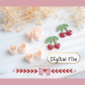 May include: Pink polymer clay cutters in heart, flower, and cherry shapes. The image features the text "Digital file" on a white and gold label, and a decorative border with hearts and a bow. The cutters are arranged on a light wooden surface.