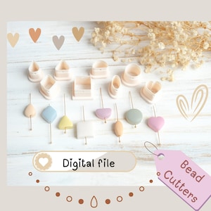 Puede incluir: Una colección de cortadores de cuentas de color rosa claro y varias cuentas de colores pastel sobre alfileres dorados. La imagen incluye el texto "Digital file" y una etiqueta rosa que dice "Bead Cutters".