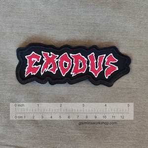 May include: Black and red embroidered patch with the word "EXODUS" in a stylized font. The patch is approximately 4 inches wide and 1 inch tall.
