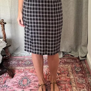 May include: A black and white plaid pencil skirt with a high waist.