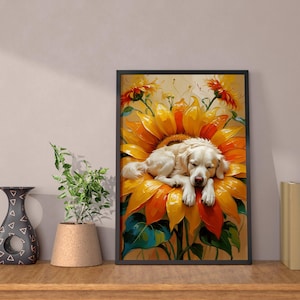 May include: A framed print shows a sleeping white dog on a large sunflower. The artwork has a black frame and is displayed on a wooden surface. Decorative items, including a vase and plant, are also visible.