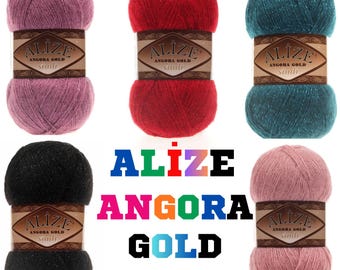 May include: A collection of Alize Angora Gold Glittery yarn balls in various colors, including pink, red, teal, black, and a lighter pink. Each ball has a label with the brand name. The word "ALİZE" and "ANGORA GOLD GLITTERY" are displayed in colorful text.