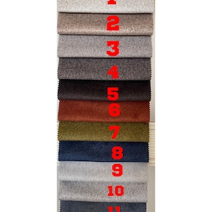 May include: A vertical display of twelve fabric swatches in various colours. The swatches are numbered 1 through 12 in red. Colours include light grey, brown, dark grey, dark brown, rust, olive green, navy blue, light grey, medium grey, and dark blue.