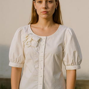 White cotton blouse puff sleeve floral ruffle front romantic vintage style elegant button up shirt