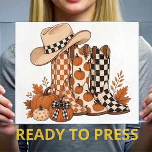 May include: A graphic illustration featuring a tan cowboy hat with a black and white checkered band, three cowboy boots with orange and black checkered patterns, and several orange pumpkins decorated with a black and white checkered bow.