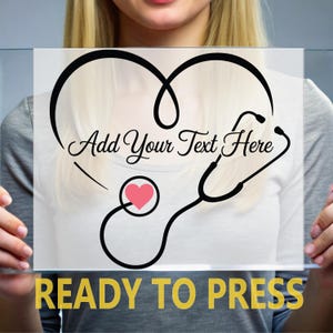May include: A clear rectangular sign featuring a black heart and stethoscope design with a pink heart accent. The text "Add Your Text Here" is above the design, and "READY TO PRESS" is at the bottom.
