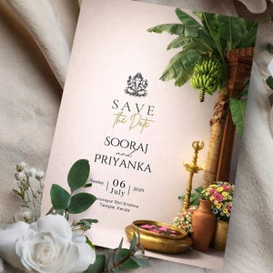 May include: A wedding invitation card with the text "Save the Date" and names "Sooraj and Priyanka". The card features floral and traditional Indian design elements, including a banana plant and a golden bowl.
