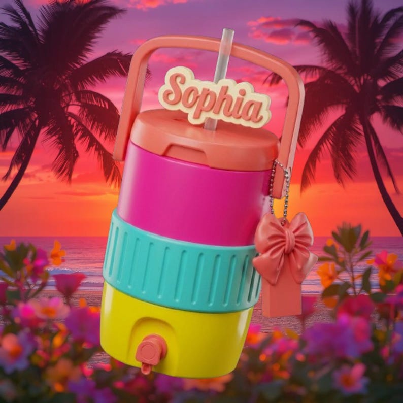 May include: A colorful, stackable water cooler with a handle, straw, and the name "Sophia" on top. The cooler is composed of pink, teal, and yellow sections. A peach-colored bow charm hangs from the side. The background features a tropical sunset.