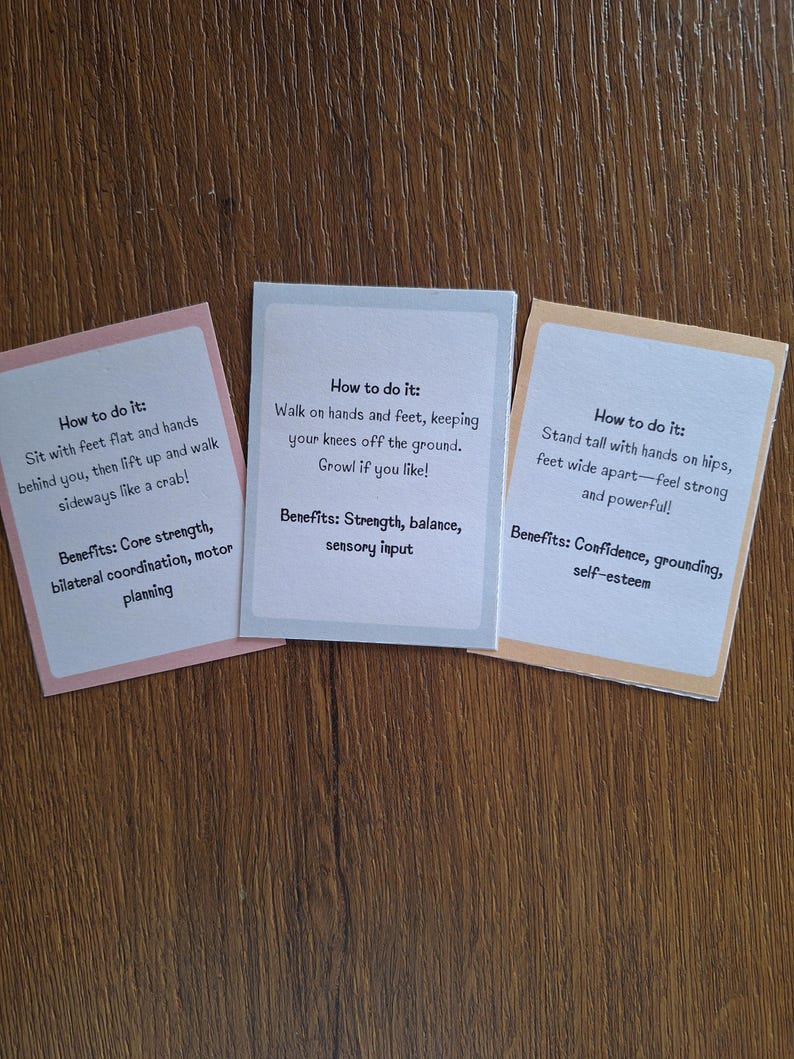 May include: Three colorful cards with instructions on how to do different exercises. The first card is pink and says "How to do it: Sit with feet flat and hands behind you, then lift up and walk sideways like a crab!" The second card is white and says "How to do it: Walk on hands and feet, keeping your knees off the ground. Growl if you like!" The third card is orange and says "How to do it: Stand tall with hands on hips, feet wide apart - feel strong and powerful!"