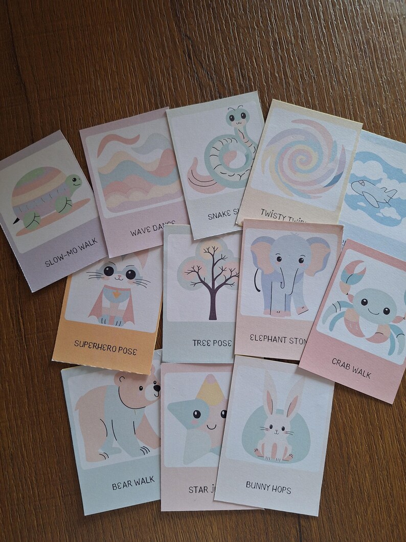 May include: A set of 12 colorful cards featuring different animal poses and actions. Each card has a cute illustration of an animal, such as a turtle, snake, elephant, crab, bear, and bunny, and a corresponding action phrase, such as "Slow-Mo Walk", "Wave Dance", "Snake Slide", "Superhero Pose", "Tree Pose", "Elephant Stomp", "Crab Walk", "Bear Walk", "Star Jump", and "Bunny Hops".