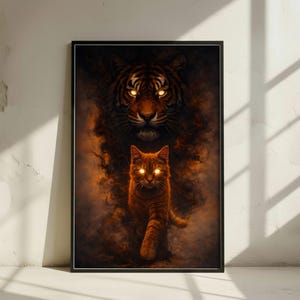 Può includere: Stampa artistica incorniciata con una tigre e un gatto con occhi luminosi. La tigre è raffigurata sopra il gatto, entrambi emergono da uno sfondo fumoso dai toni arancioni. L'opera è incorniciata in un bordo nero.