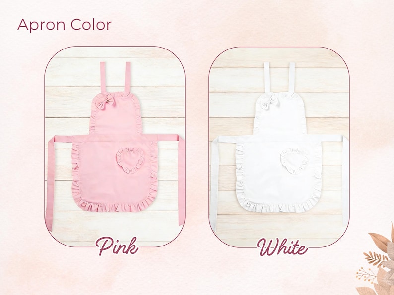 Pode incluir: S&atilde;o apresentados dois aventais, um rosa e outro branco. Cada avental tem uma borda com babados, um patch em forma de cora&ccedil;&atilde;o e um la&ccedil;o na parte superior. O texto "Apron Color" est&aacute; no topo, e "Pink" e "White" est&atilde;o escritos abaixo.